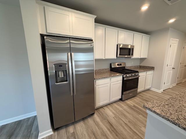 1214 Forestbrook, Spartanburg, SC 29303 - kitchen featuring stainless steel appliances, light wood finished floors, baseboards, stone countertops, and recessed lighting