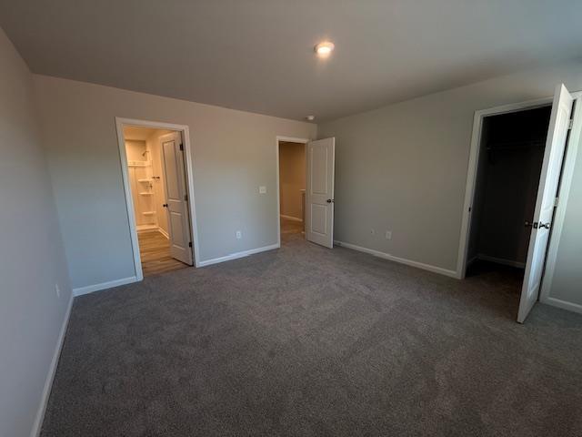 1214 Forestbrook, Spartanburg, SC 29303 - unfurnished bedroom with carpet floors, baseboards, and ensuite bath