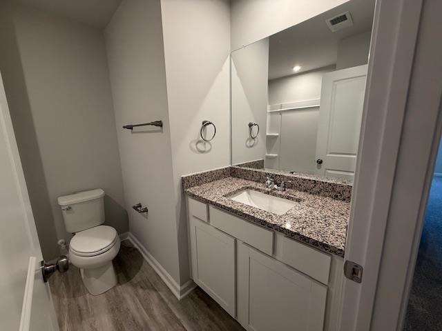 1214 Forestbrook, Spartanburg, SC 29303 - bathroom with toilet, wood finished floors, vanity, and baseboards