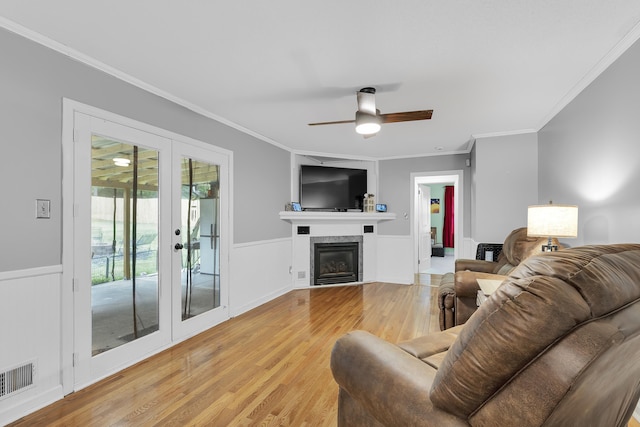 469 Royal Oak, Spartanburg, SC 29302 - living area with crown molding, light wood-type flooring, french doors, ceiling fan, and a wainscoted wall