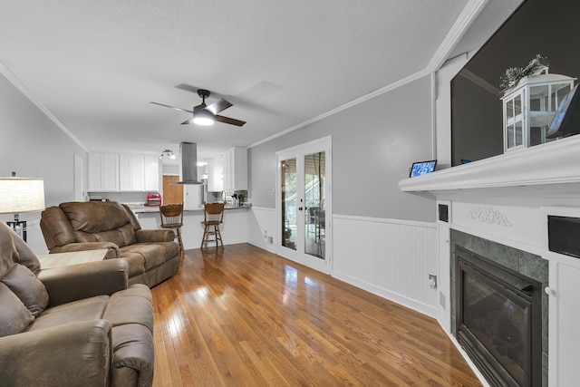 469 Royal Oak, Spartanburg, SC 29302 - living area with ornamental molding, wainscoting, light wood-type flooring, a fireplace, and a ceiling fan