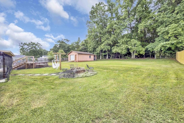 469 Royal Oak, Spartanburg, SC 29302 - view of yard with an outbuilding, a fire pit, a deck, and view of wooded area