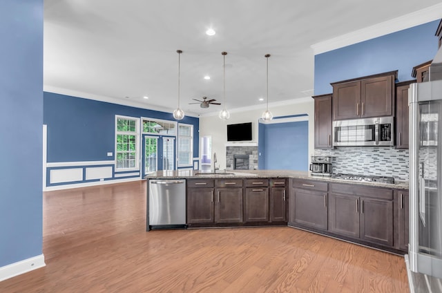 267 Santa Ana, Duncan, SC 29334 - kitchen featuring stainless steel appliances, a sink, crown molding, dark brown cabinets, and a ceiling fan