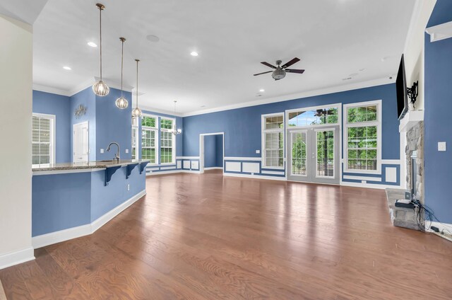 267 Santa Ana, Duncan, SC 29334 - unfurnished living room featuring a ceiling fan, crown molding, a stone fireplace, recessed lighting, and wood finished floors