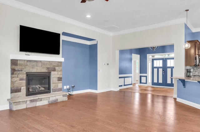 267 Santa Ana, Duncan, SC 29334 - unfurnished living room with wood finished floors, crown molding, a ceiling fan, a stone fireplace, and baseboards