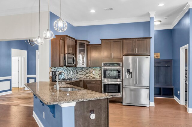 267 Santa Ana, Duncan, SC 29334 - kitchen with stainless steel appliances, a sink, light stone countertops, glass insert cabinets, and wood finished floors
