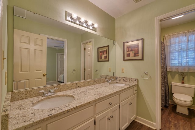 201 Woodridge, Spartanburg, SC 29301 - bathroom with wood finished floors, toilet, double vanity, and baseboards