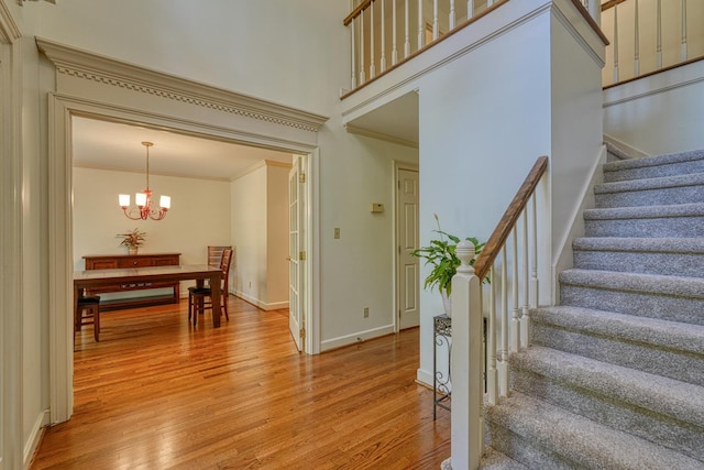201 Woodridge, Spartanburg, SC 29301 - staircase with wood finished floors, crown molding, a chandelier, and baseboards