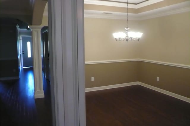 415 Abernathy, Inman, SC 29349 - hall with dark wood-style floors, arched walkways, decorative columns, crown molding, and a chandelier