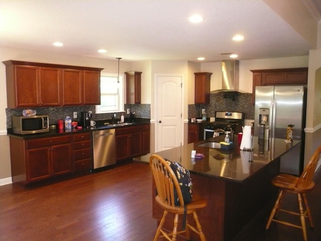 415 Abernathy, Inman, SC 29349 - kitchen featuring wall chimney exhaust hood, appliances with stainless steel finishes, dark countertops, decorative backsplash, and a breakfast bar area