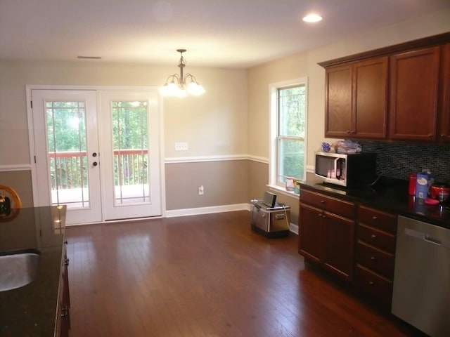 415 Abernathy, Inman, SC 29349 - kitchen featuring stainless steel appliances, dark countertops, dark wood-type flooring, brown cabinetry, and decorative light fixtures