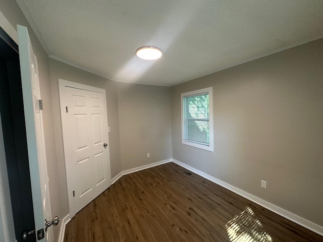121 Pacolet, Gaffney, SC 29340 - spare room featuring dark wood-type flooring, baseboards, crown molding, and a textured ceiling