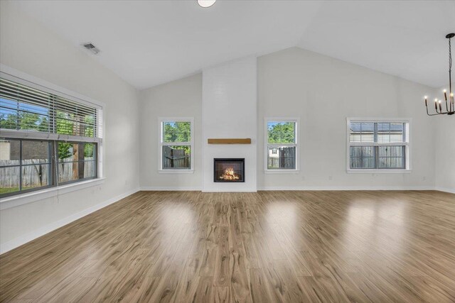 624 Renita, Boiling Springs, SC 29316 - unfurnished living room with a chandelier, healthy amount of natural light, high vaulted ceiling, a fireplace, and wood finished floors