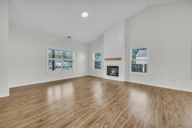 624 Renita, Boiling Springs, SC 29316 - unfurnished living room featuring wood finished floors, high vaulted ceiling, a glass covered fireplace, and baseboards