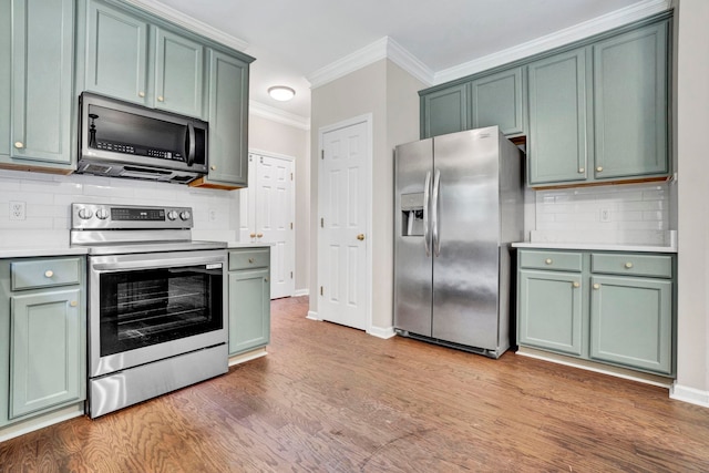905 Morning Mist, Simpsonville, SC 29680 - kitchen featuring appliances with stainless steel finishes, green cabinetry, crown molding, light countertops, and backsplash