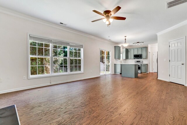 905 Morning Mist, Simpsonville, SC 29680 - unfurnished living room featuring crown molding, dark wood-style flooring, a ceiling fan, and baseboards