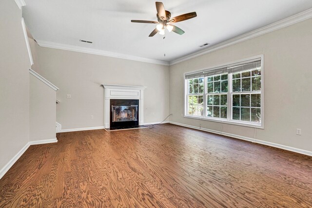 905 Morning Mist, Simpsonville, SC 29680 - unfurnished living room featuring wood finished floors, a ceiling fan, a glass covered fireplace, crown molding, and baseboards