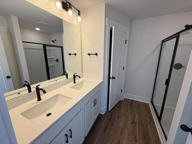 534 W Norvell Ct, Spartanburg, SC 29307 - bathroom featuring a shower stall, double vanity, wood finished floors, and baseboards