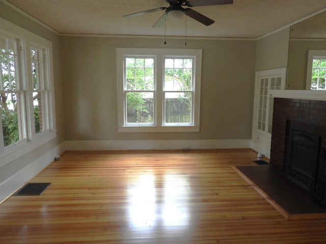 823 W Smith St, Gaffney, SC 29341 - unfurnished living room featuring ceiling fan, light wood-style flooring, ornamental molding, baseboards, and a brick fireplace