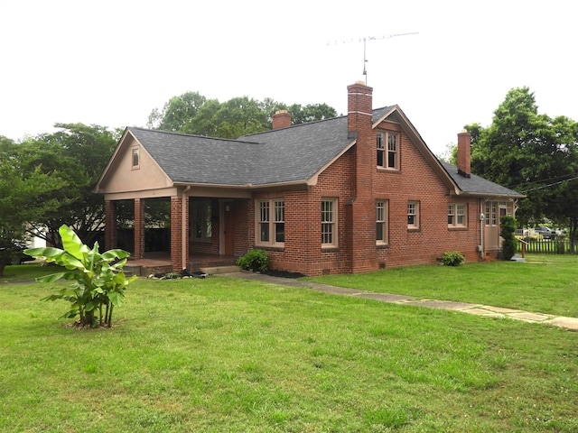 823 W Smith St, Gaffney, SC 29341 - rear view of house with a chimney, a yard, brick siding, covered porch, and roof with shingles