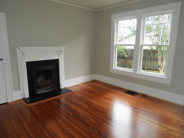 823 W Smith St, Gaffney, SC 29341 - unfurnished living room featuring a fireplace with raised hearth, wood finished floors, crown molding, and baseboards