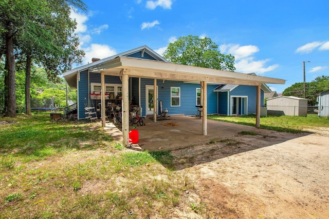 1050 W Blackstock, Spartanburg, SC 29301 - back of house featuring a trampoline, a carport, and a patio area