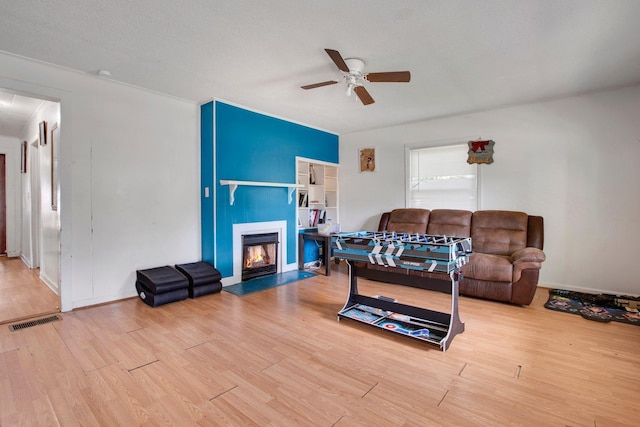 1050 W Blackstock, Spartanburg, SC 29301 - living area featuring a fireplace with flush hearth, ceiling fan, wood finished floors, and baseboards