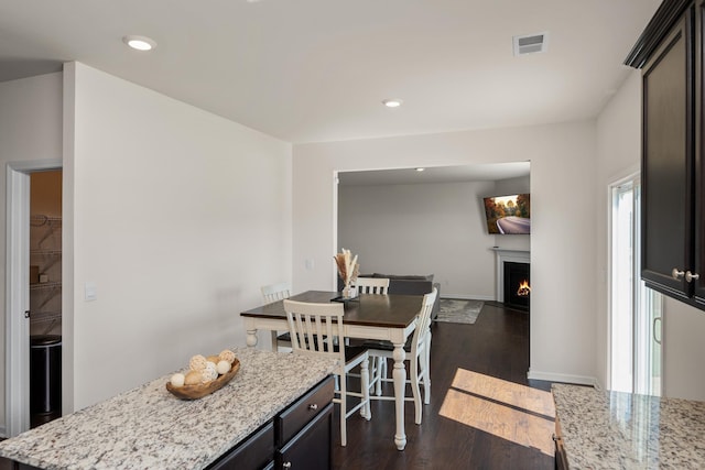 912 Brynderwen, Lyman, SC 29365 - dining space with a warm lit fireplace, dark wood finished floors, baseboards, and recessed lighting