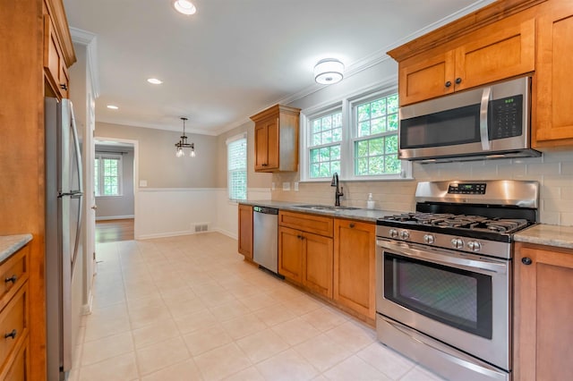 236 S Park, Spartanburg, SC 29302 - kitchen featuring appliances with stainless steel finishes, a sink, brown cabinets, crown molding, and a wainscoted wall