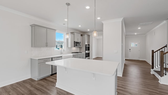 315 Fiery, Mauldin, SC 29607 - kitchen featuring stainless steel appliances, ornamental molding, gray cabinetry, healthy amount of natural light, and light countertops