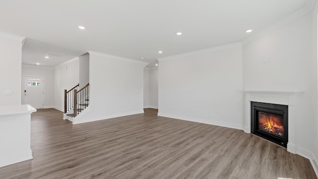 315 Fiery, Mauldin, SC 29607 - unfurnished living room with crown molding, wood finished floors, stairway, recessed lighting, and a glass covered fireplace