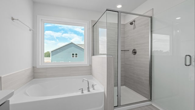 315 Fiery, Mauldin, SC 29607 - bathroom featuring healthy amount of natural light, a garden tub, a stall shower, and vanity