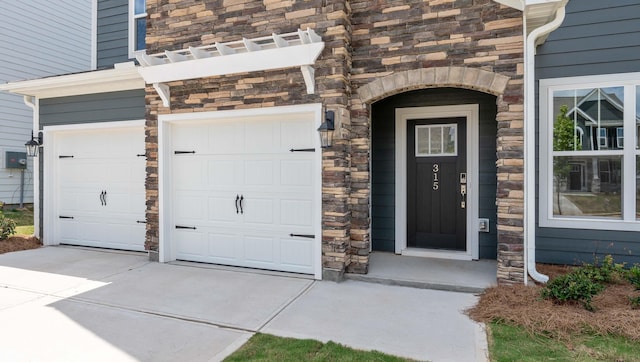 315 Fiery, Mauldin, SC 29607 - property entrance with stone siding, driveway, and an attached garage