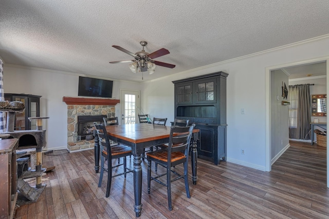 955 Baggett Rd, Enoree, SC 29335 - dining room with a ceiling fan, a fireplace, wood finished floors, ornamental molding, and a textured ceiling