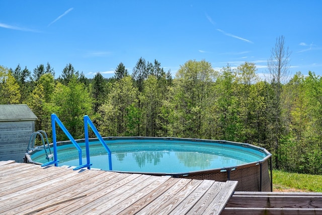 955 Baggett Rd, Enoree, SC 29335 - swimming pool with a wooded view and a wooden deck