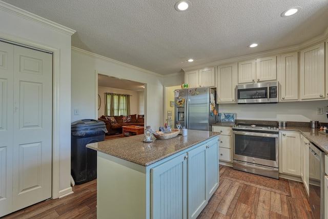 955 Baggett Rd, Enoree, SC 29335 - kitchen with stainless steel appliances, ornamental molding, dark wood-style flooring, a textured ceiling, and a kitchen island