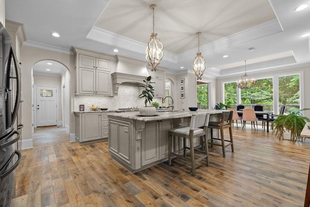 127 Turnberry, Spartanburg, SC 29306 - kitchen featuring a raised ceiling, freestanding refrigerator, gray cabinets, a chandelier, and arched walkways