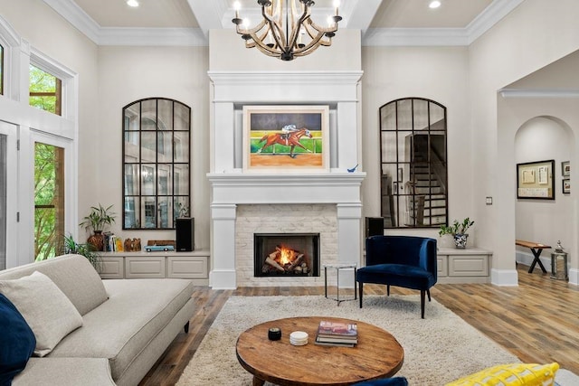 127 Turnberry, Spartanburg, SC 29306 - living room featuring wood finished floors, a chandelier, crown molding, a tile fireplace, and a high ceiling
