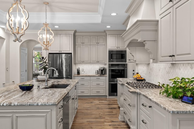 127 Turnberry, Spartanburg, SC 29306 - kitchen featuring appliances with stainless steel finishes, a sink, arched walkways, recessed lighting, and premium range hood