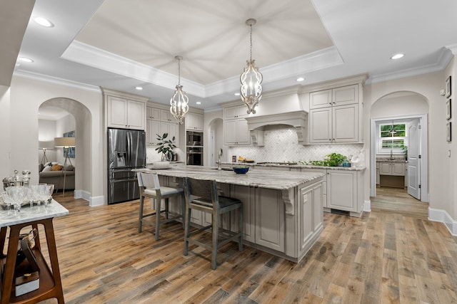 127 Turnberry, Spartanburg, SC 29306 - kitchen featuring appliances with stainless steel finishes, tasteful backsplash, light wood-style flooring, a kitchen bar, and recessed lighting
