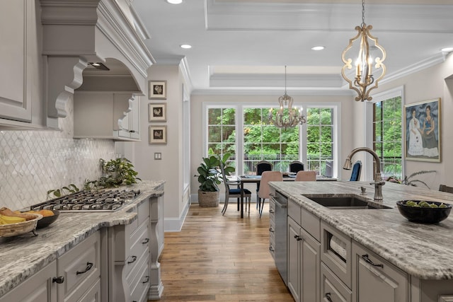 127 Turnberry, Spartanburg, SC 29306 - kitchen with a sink, a chandelier, appliances with stainless steel finishes, wood finished floors, and decorative backsplash