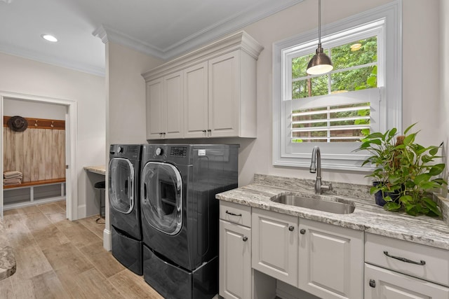 127 Turnberry, Spartanburg, SC 29306 - laundry area featuring washer and dryer, cabinet space, crown molding, and light wood-type flooring