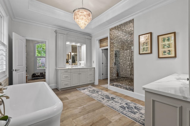 127 Turnberry, Spartanburg, SC 29306 - bathroom featuring vanity, a chandelier, a freestanding tub, wood finished floors, and crown molding