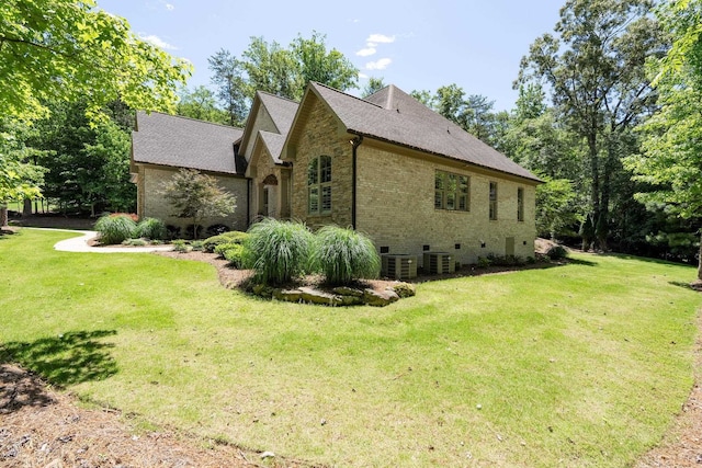 127 Turnberry, Spartanburg, SC 29306 - view of home's exterior with central AC, a yard, brick siding, and roof with shingles