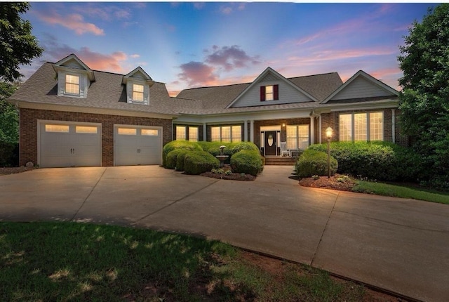 404 N Tidewater, Inman, SC 29349 - view of front of property featuring brick siding, concrete driveway, an attached garage, covered porch, and roof with shingles
