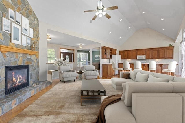 404 N Tidewater, Inman, SC 29349 - living area with a ceiling fan, a stone fireplace, light wood finished floors, high vaulted ceiling, and recessed lighting