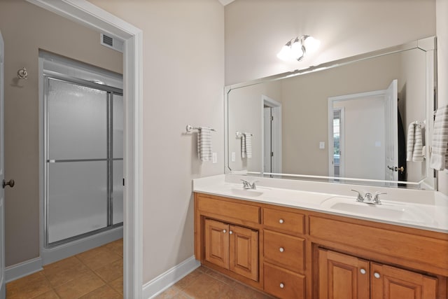 404 N Tidewater, Inman, SC 29349 - bathroom featuring double vanity, a stall shower, tile patterned flooring, and baseboards