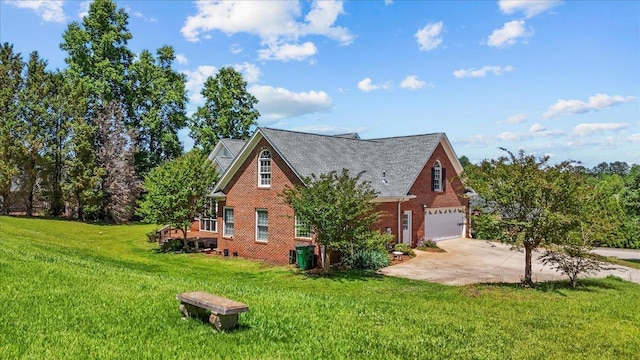 123 S Lake Emory, Inman, SC 29349 - view of side of property with concrete driveway, brick siding, an attached garage, and a lawn