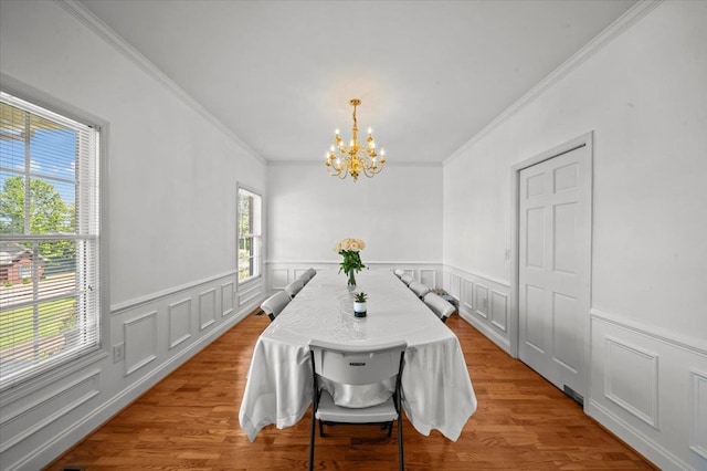 123 S Lake Emory, Inman, SC 29349 - dining space with a chandelier, crown molding, a wainscoted wall, wood finished floors, and a decorative wall