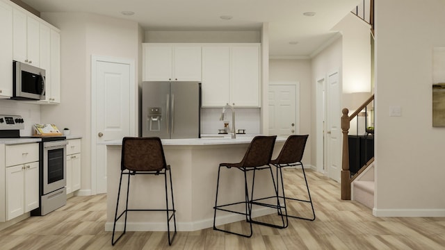 1612 Wren Crk, Boiling Springs, SC 29316 - kitchen with appliances with stainless steel finishes, tasteful backsplash, white cabinetry, a kitchen breakfast bar, and light wood finished floors